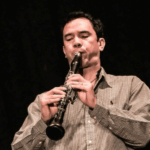 Musician blowing a horn instrument